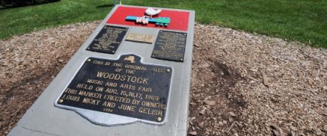 TO GO WITH AFP STORIES "US-MUSIC-SOCIETY-HISTORY-WOODSTOCK" A monument at the site of the Woodstock Music and Arts Fair, next to the Bethel Woods Center for the Arts is seen on August 3, 2009 in Bethel, New York. This year marks the 40th anniversary of the iconic concert held August 15-18, 1969 on the farm of local resident Max Yasgur. The original stage was on the bare ground beyond the fence where more than 30 acts played to an estimated 450,000 people, who occupied the grassy area in the background. AFP PHOTO/Stan Honda (Photo credit should read STAN HONDA/AFP/Getty Images)