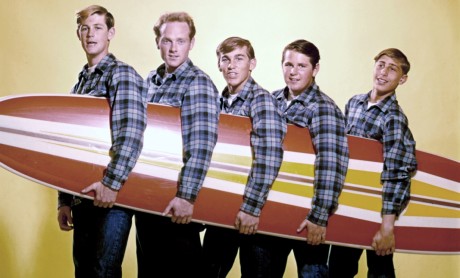 LOS ANGELES - AUGUST 1962: Rock and roll band "The Beach Boys" pose for a portrait with a surfboard in August 1962 in Los Angeles, California. (L-R) Brian Wilson, Mike Love, Dennis Wilson, Carl Wilson, David Marks. This image was used on the cover of 'Surfin' USA'. (Photo by Michael Ochs Archives/Getty Images)